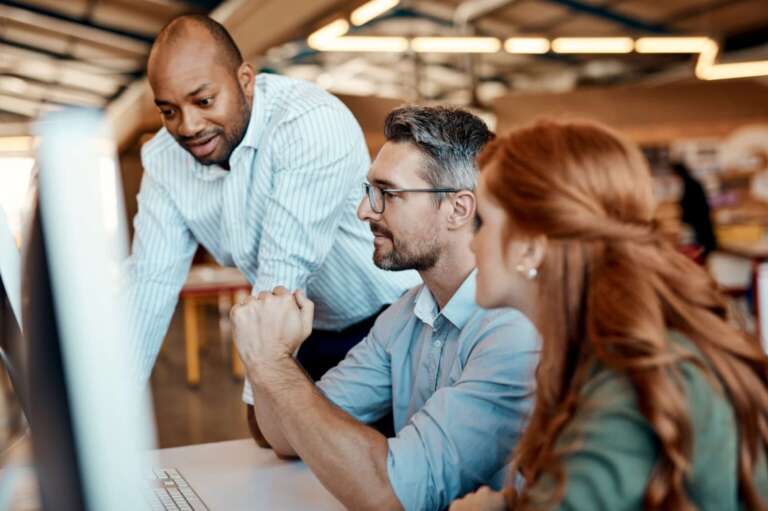 colleagues reviewing screen office